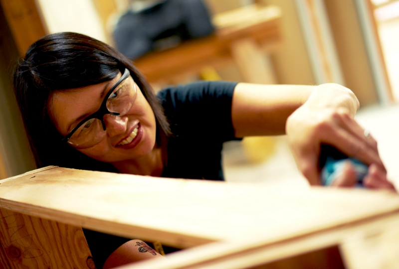 female carpentry student working on wood project
