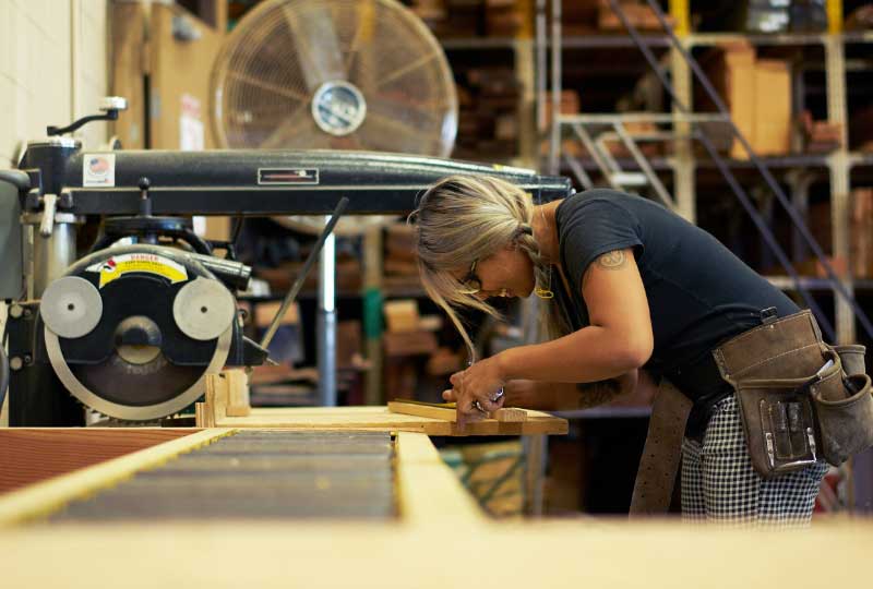 Female student using table saw